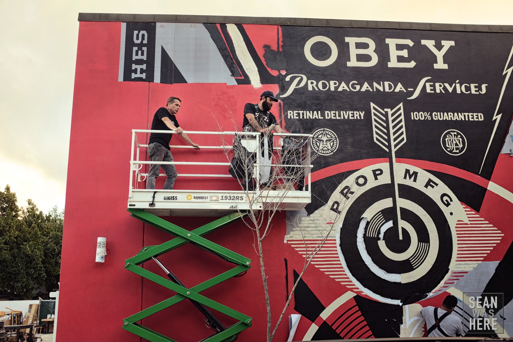 Shepard Fairey (OBEY) with his mural in progress. Wynwood Miami